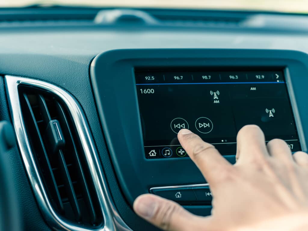 a driver using a car's infotainment system